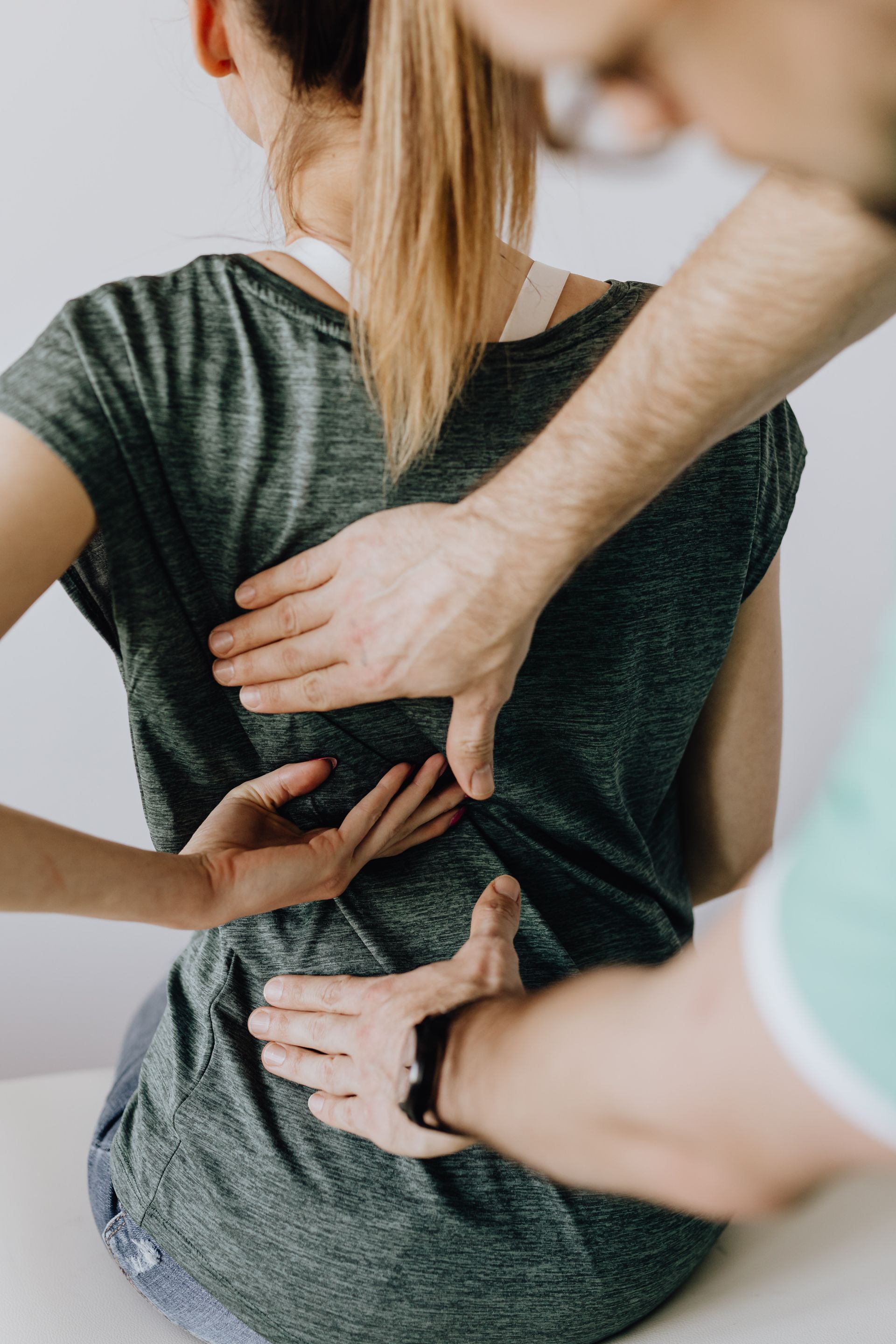 Chiropractor performing a treatment adjustment on a patient